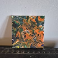 Orange and green marbling with black veins on a small canvas