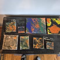 Marbling canvases lined up in the studio