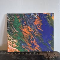 Green, orange, and blue marbling on a square canvas