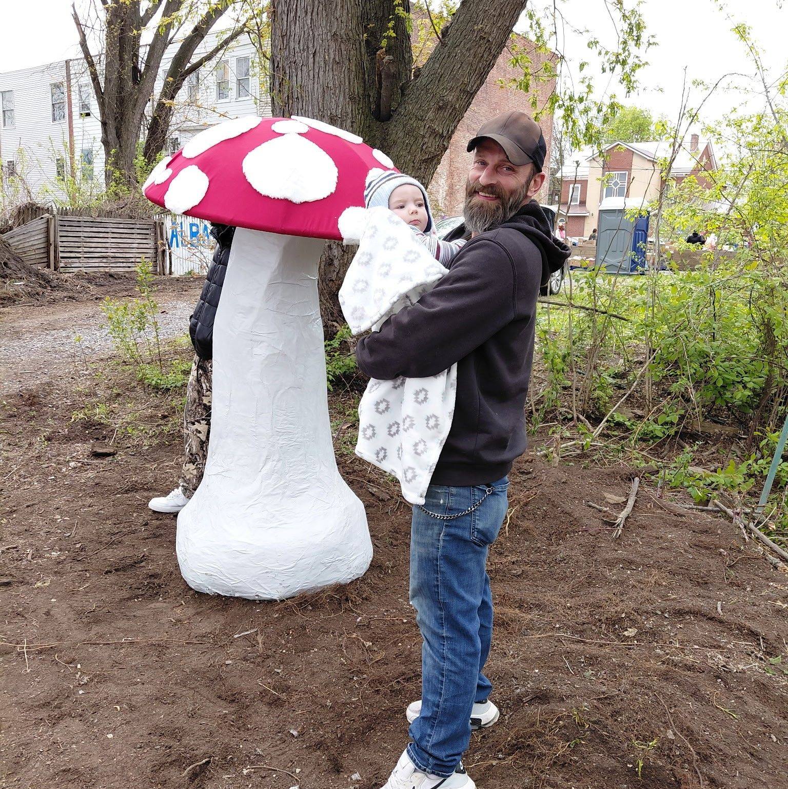 Mushy-Lisa — giant mushroom sculpture outdoors with red-and-white cap